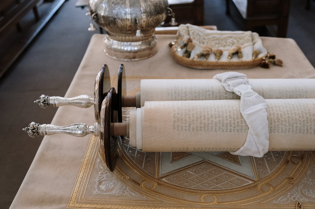 creative-02 Sefer Torah scroll displayed on a bimah in a synagogue setting, showcasing rich cultural heritage.