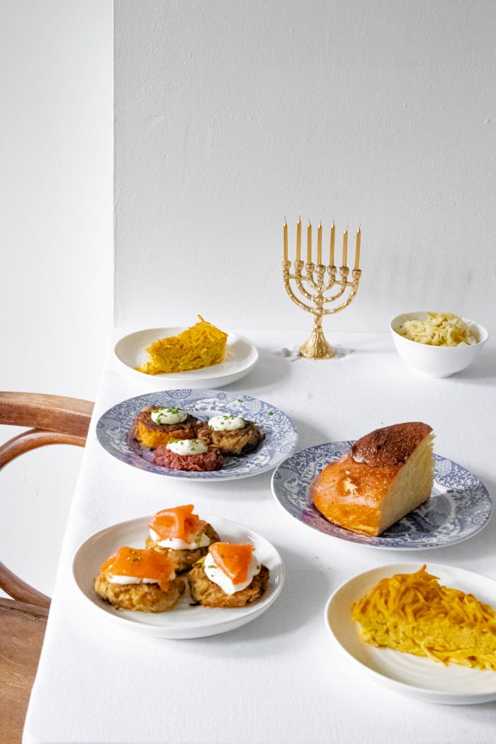 digital-01 Jewish cuisine featuring traditional Hanukkah dishes and a menorah on a dining table.